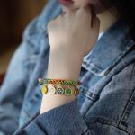 Bracelet-porte-bonheur-tibetain-tresse-multicolore-a-medaillons-dores-emailles-picture-2