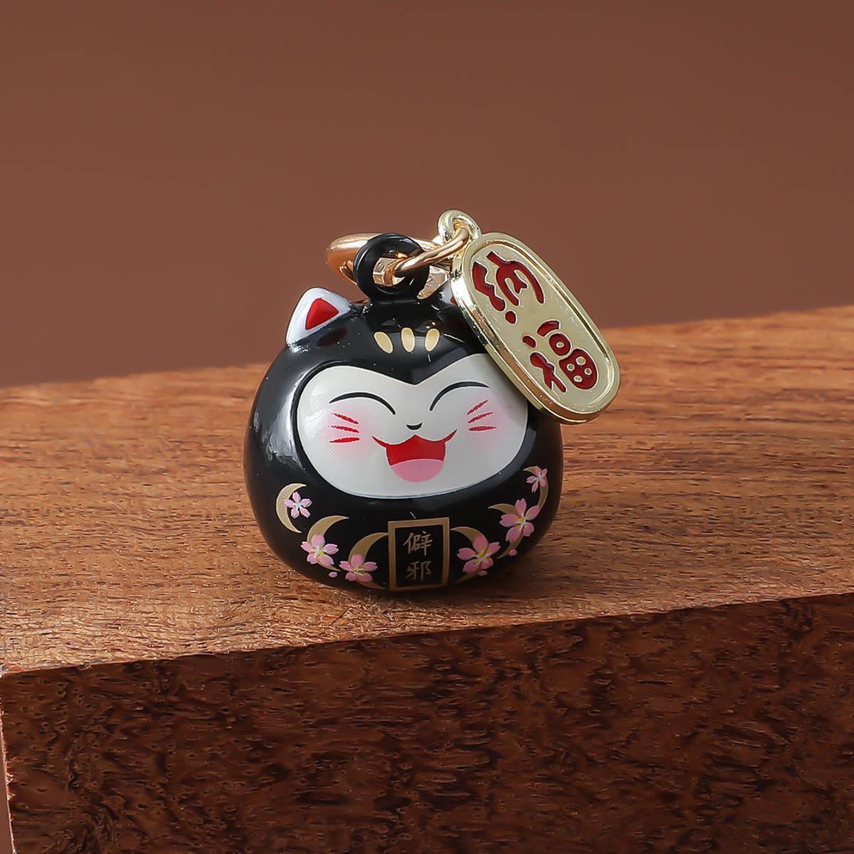 Porte-clé maneki neko daruma en émail avec clochette dorée et motifs floraux - Noir