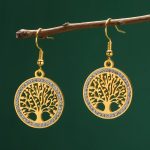 Boucles acier inoxydable pendantes ornées d'un arbre de vie ajouré serti de strass