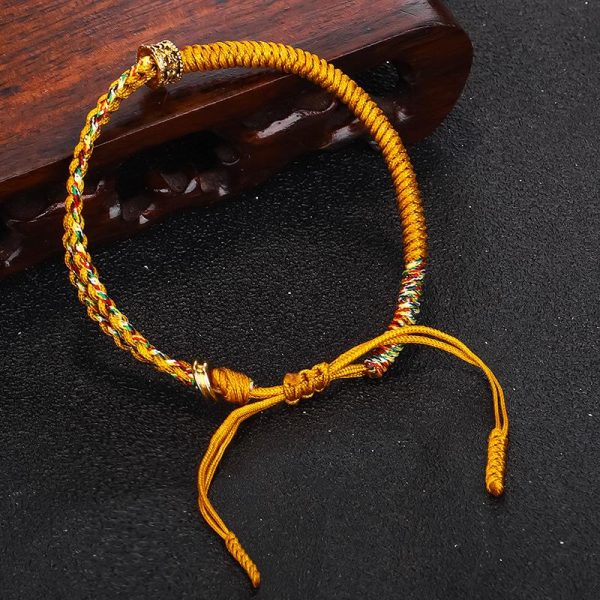 Bracelet coulissant cordon tressé artisanal avec perle en cuivre doré gravé