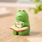 Figurine de grenouille en résine dans un fauteuil à bascule miniature