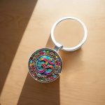 Porte-clé Om en verre bombé avec mandala steampunk et engrenages dorés